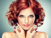 Pretty red haired girl with curls , fashionable makeup and violet manicure.  Charming look.