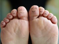Feet with happy face drawings of different characters